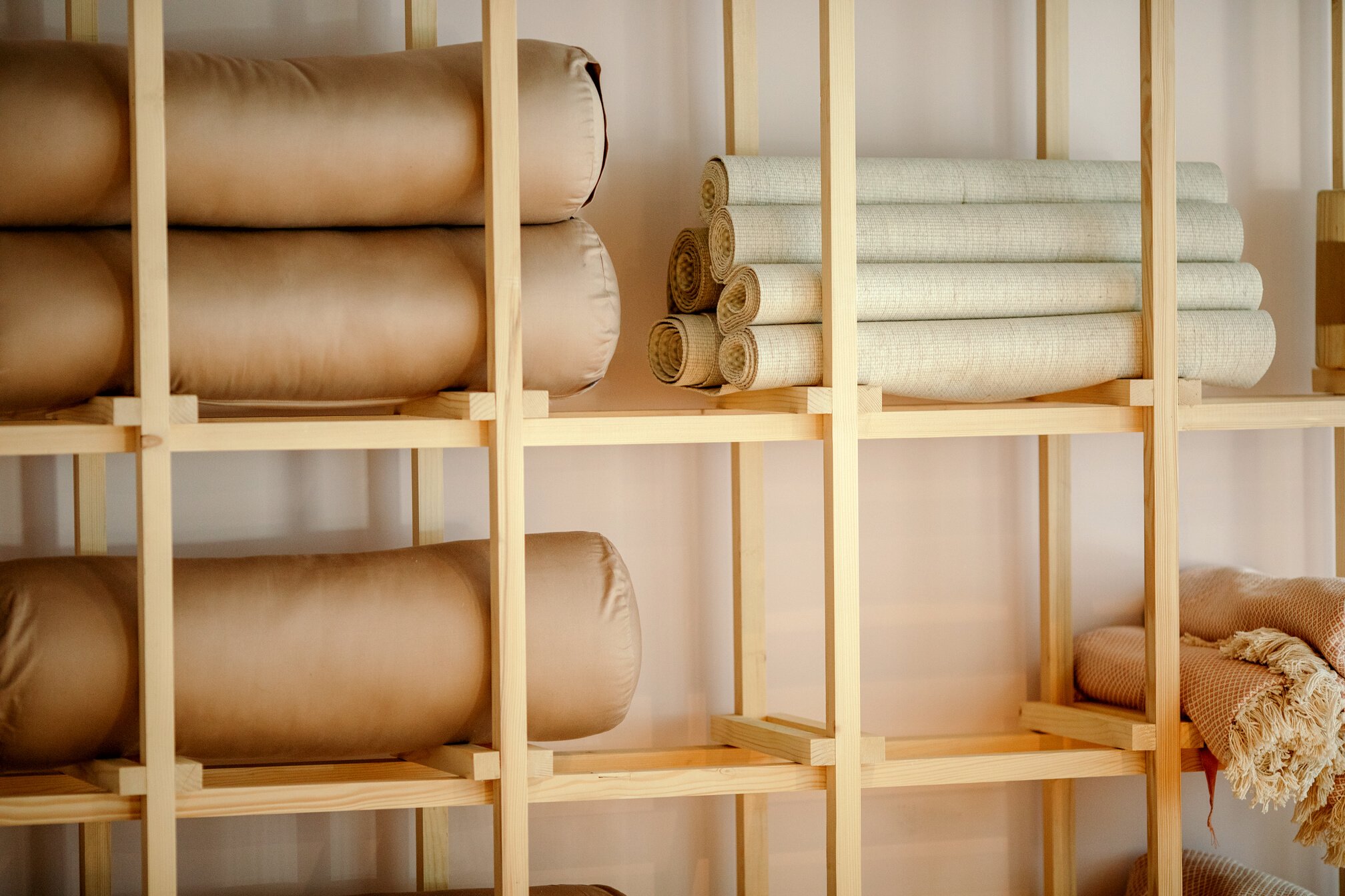 Yoga mats on shelves in yoga studio